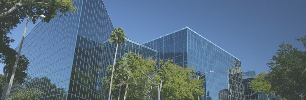large buildings with trees in front of them background image